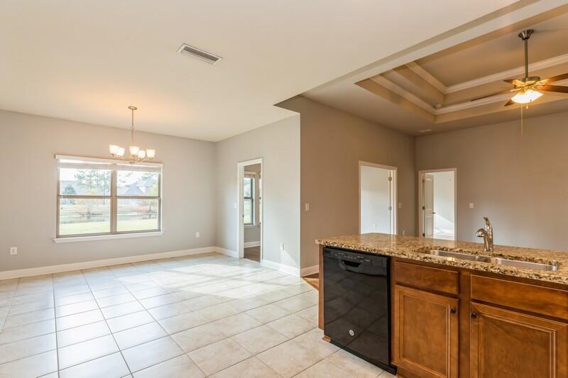 169 Windchime Way Freeport, FL 32439 - Photo 17 of 67 a bathroom with a granite countertop sink a vanity and mirror
