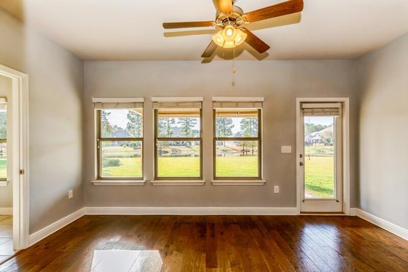 169 Windchime Way Freeport, FL 32439 - Photo 18 of 67 a view of an empty room with wooden floor and a window