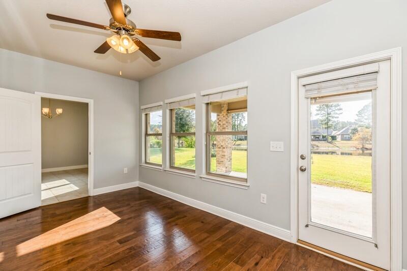 169 Windchime Way Freeport, FL 32439 - Photo 19 of 67 a view of an empty room with wooden floor and a window