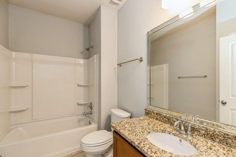 169 Windchime Way Freeport, FL 32439 - Photo 24 of 67 a bathroom with a granite countertop sink toilet and shower