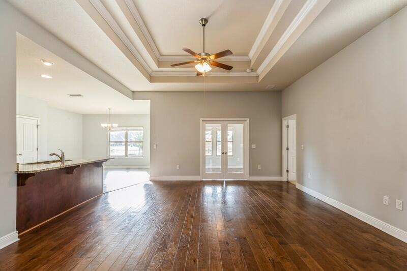 169 Windchime Way Freeport, FL 32439 - Photo 25 of 67 a view of an empty room with window and wooden floor