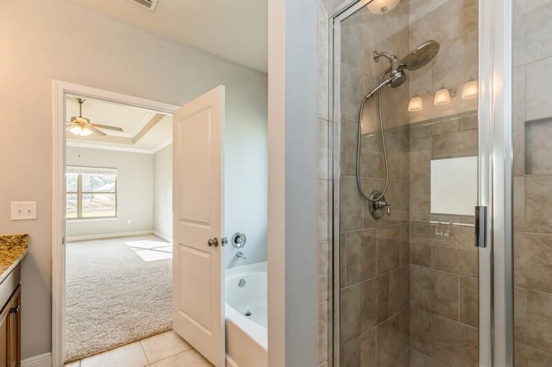 169 Windchime Way Freeport, FL 32439 - Photo 31 of 67 a bathroom with a glass shower door and a sink