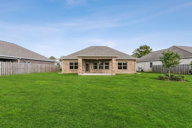 169 Windchime Way Freeport, FL 32439 - Photo 37 of 67 a front view of a house with a garden