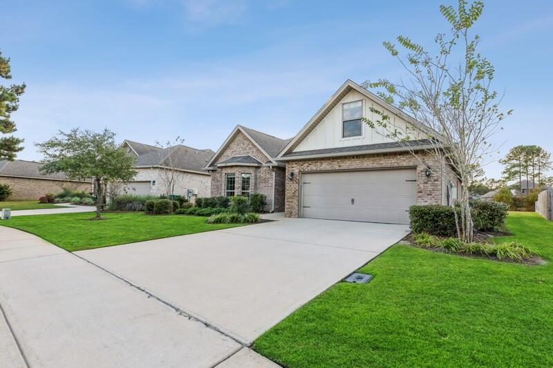 169 Windchime Way Freeport, FL 32439 - Photo 4 of 67 a front view of a house with a yard and garage