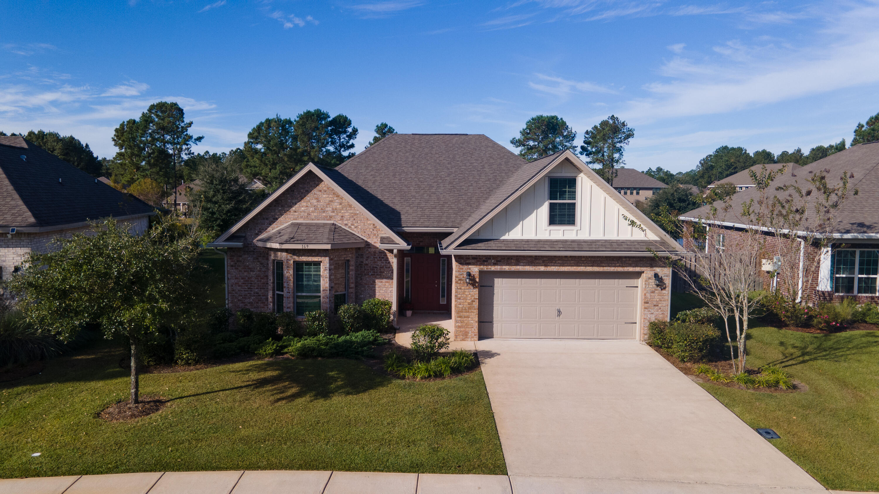 169 Windchime Way Freeport, FL 32439 - Photo 44 of 67 a front view of a house with a yard and garage