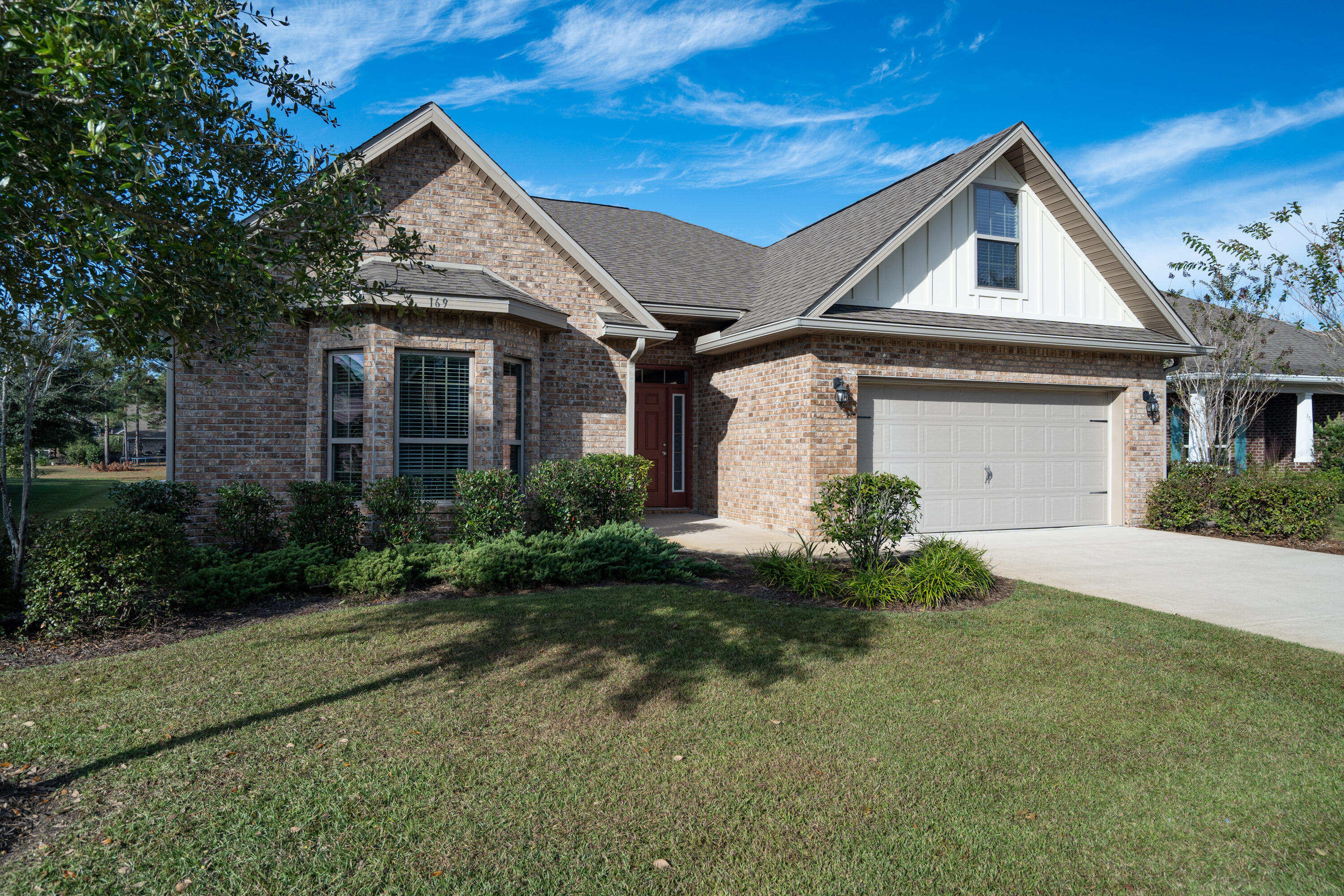 169 Windchime Way Freeport, FL 32439 - Photo 45 of 67 a front view of a house with garden