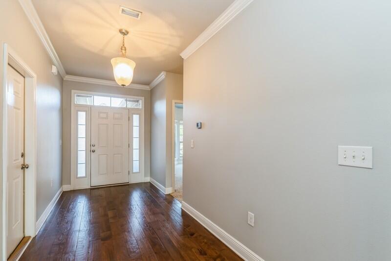 169 Windchime Way Freeport, FL 32439 - Photo 9 of 67 a view of a hallway with wooden floor