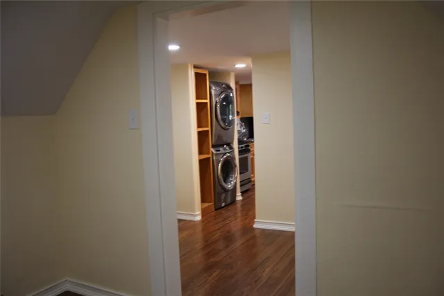 a view of a hallway with wooden shelves