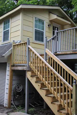 a view of a house with wooden deck