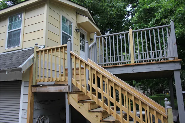a view of a balcony with wooden floor and fence