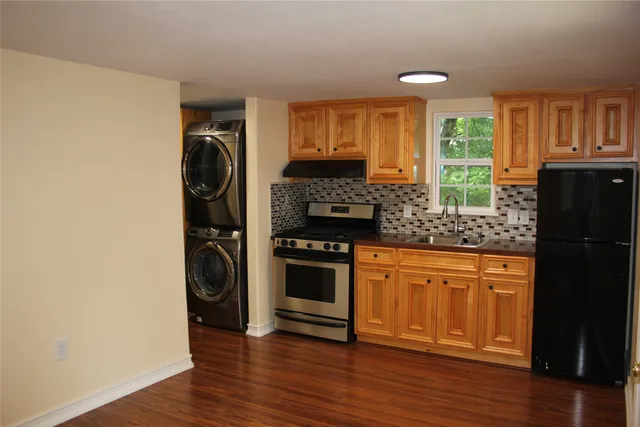 a kitchen with stainless steel appliances granite countertop a refrigerator and a stove top oven