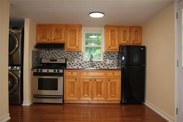 a kitchen with stainless steel appliances granite countertop a refrigerator stove and sink