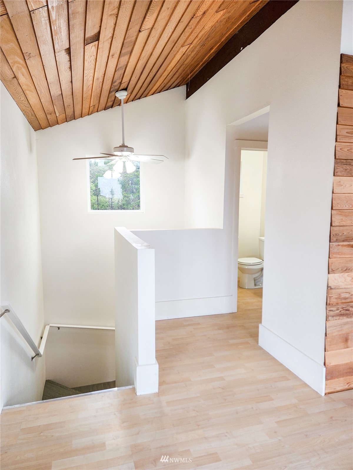 39 Ocean Lane Copalis Beach, WA 98535 - Photo 11 of 21 a view of a room with wooden floor and staircase