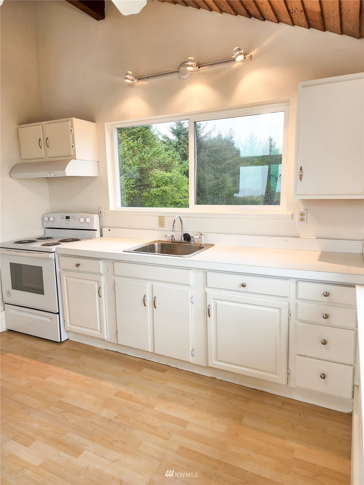 39 Ocean Lane Copalis Beach, WA 98535 - Photo 12 of 21 a white kitchen with a stove top oven sink and window