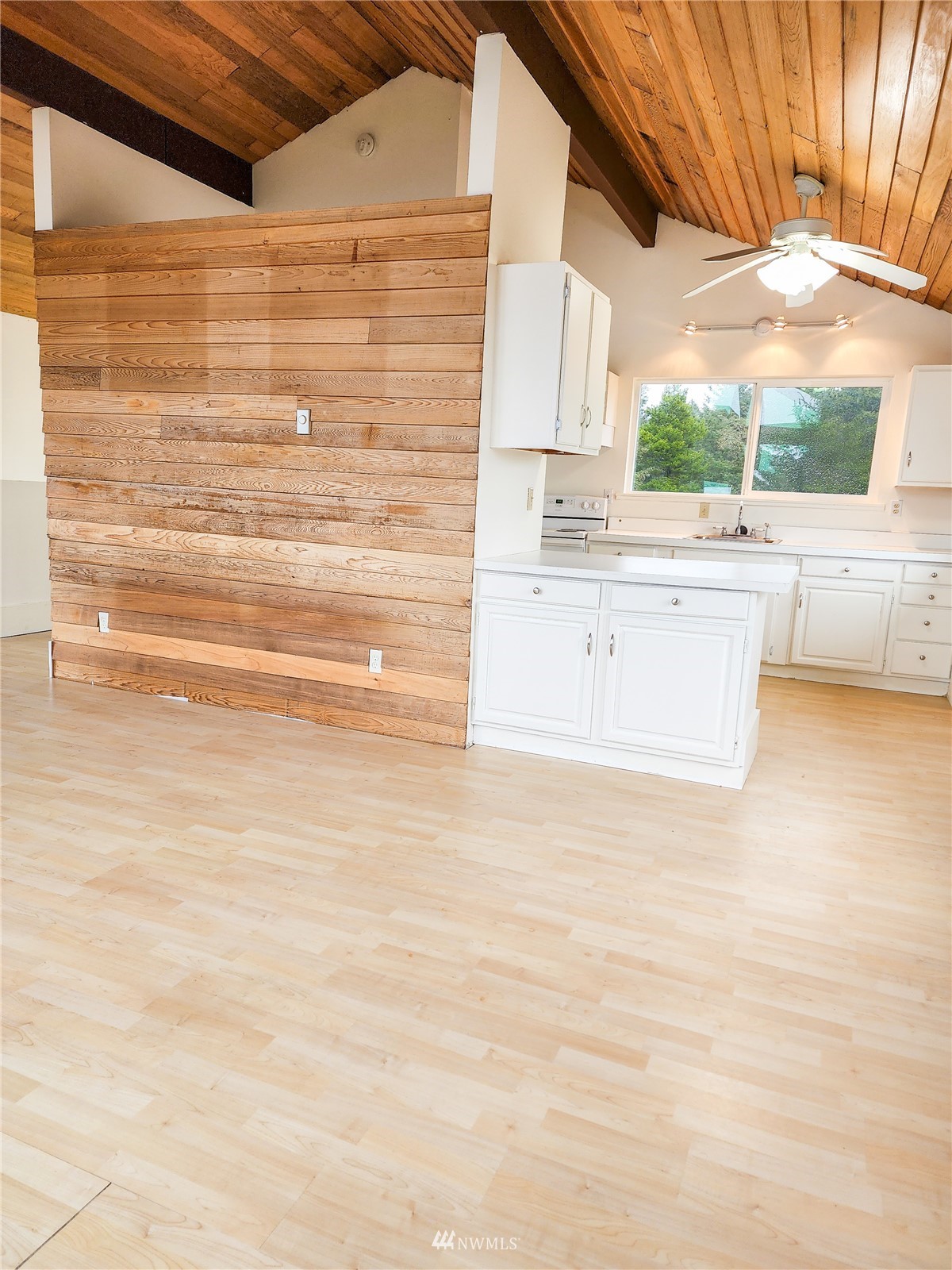 39 Ocean Lane Copalis Beach, WA 98535 - Photo 14 of 21 a view of kitchen with wooden floor and cabinets