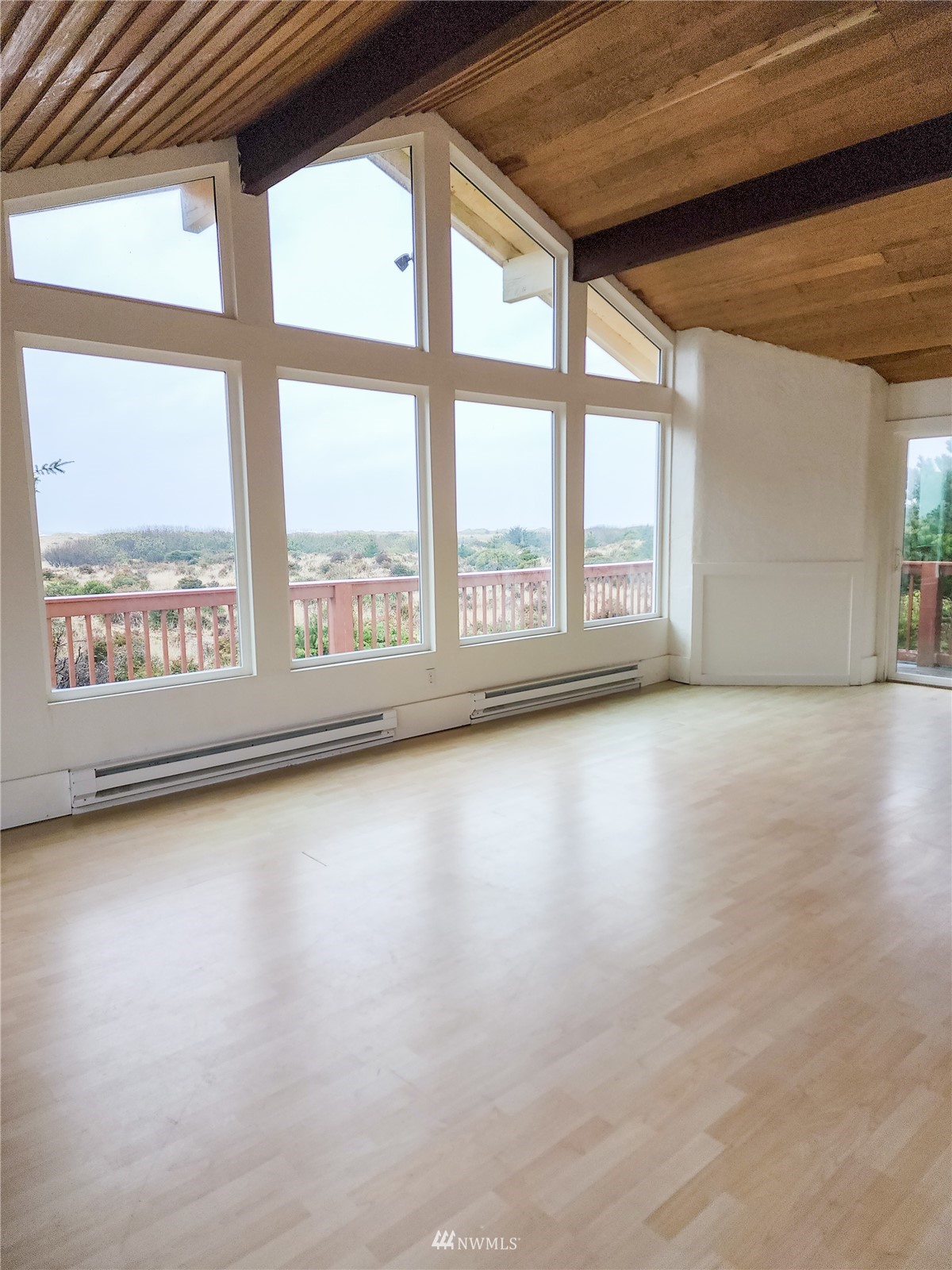 39 Ocean Lane Copalis Beach, WA 98535 - Photo 15 of 21 an empty room with wooden floor and windows