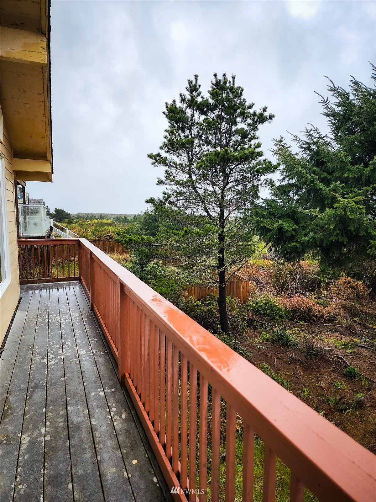 39 Ocean Lane Copalis Beach, WA 98535 - Photo 18 of 21 a view of balcony with wooden floor and fence