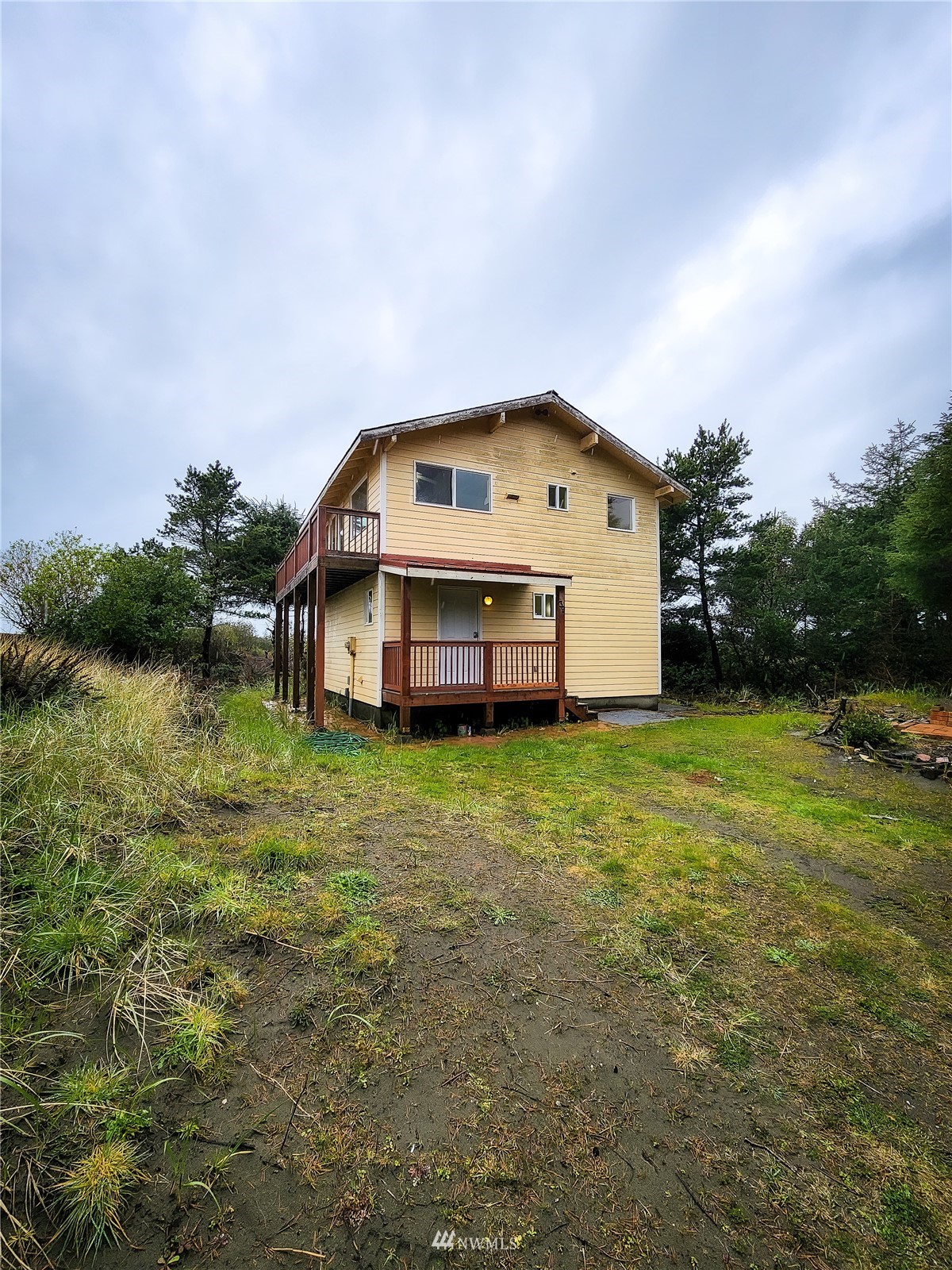 39 Ocean Lane Copalis Beach, WA 98535 - Photo 3 of 21 a front view of house with garden