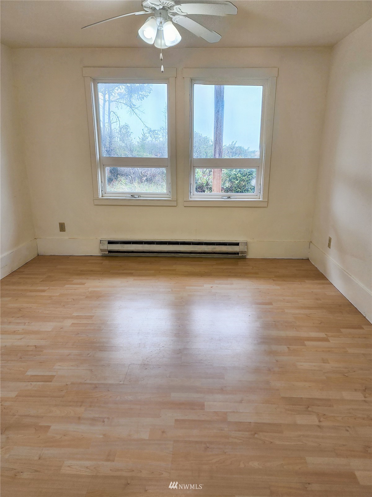 39 Ocean Lane Copalis Beach, WA 98535 - Photo 7 of 21 an empty room with wooden floor and windows