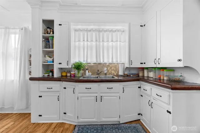 a kitchen with granite countertop white cabinets and white appliances