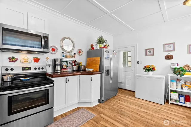 a kitchen with stainless steel appliances a stove a microwave and cabinets