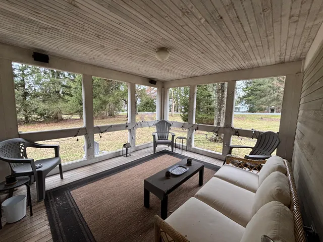 a living room with furniture and a floor to ceiling window