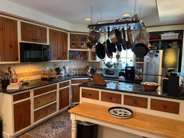 a kitchen with a sink a stove and cabinets