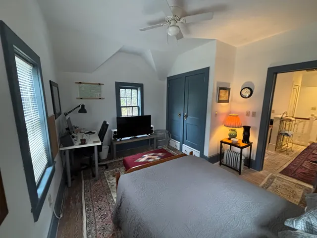 a bedroom with furniture and a window