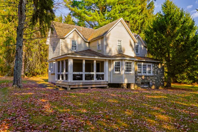 a view of a house with a yard and sitting area