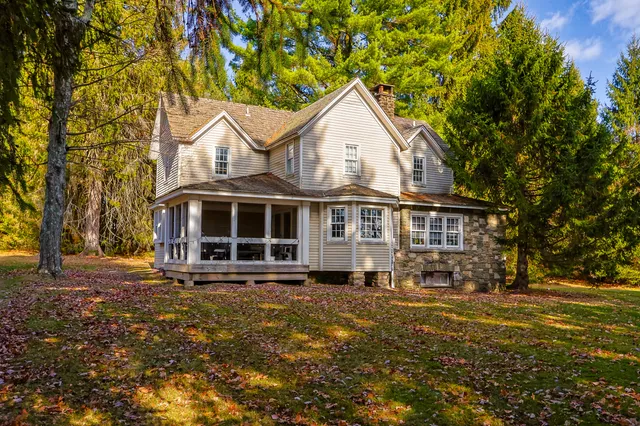 a view of a white house with a yard