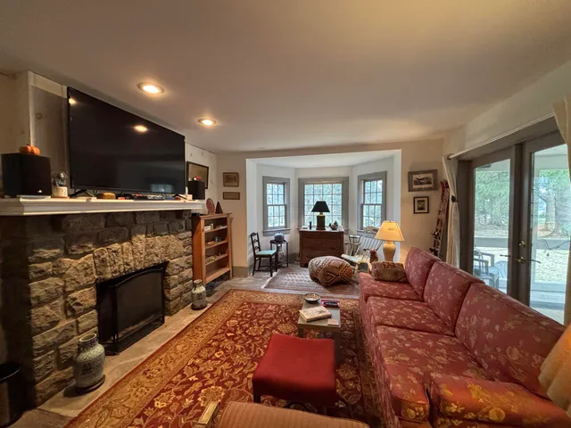 a living room with furniture a flat screen tv and a fireplace
