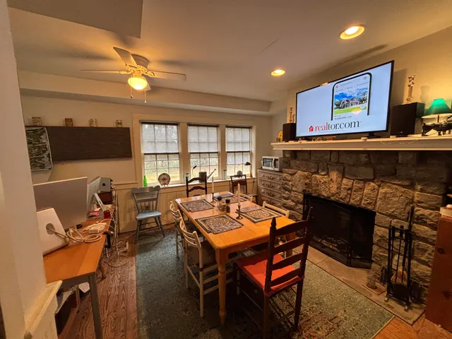 a living room with furniture a fireplace and a flat screen tv