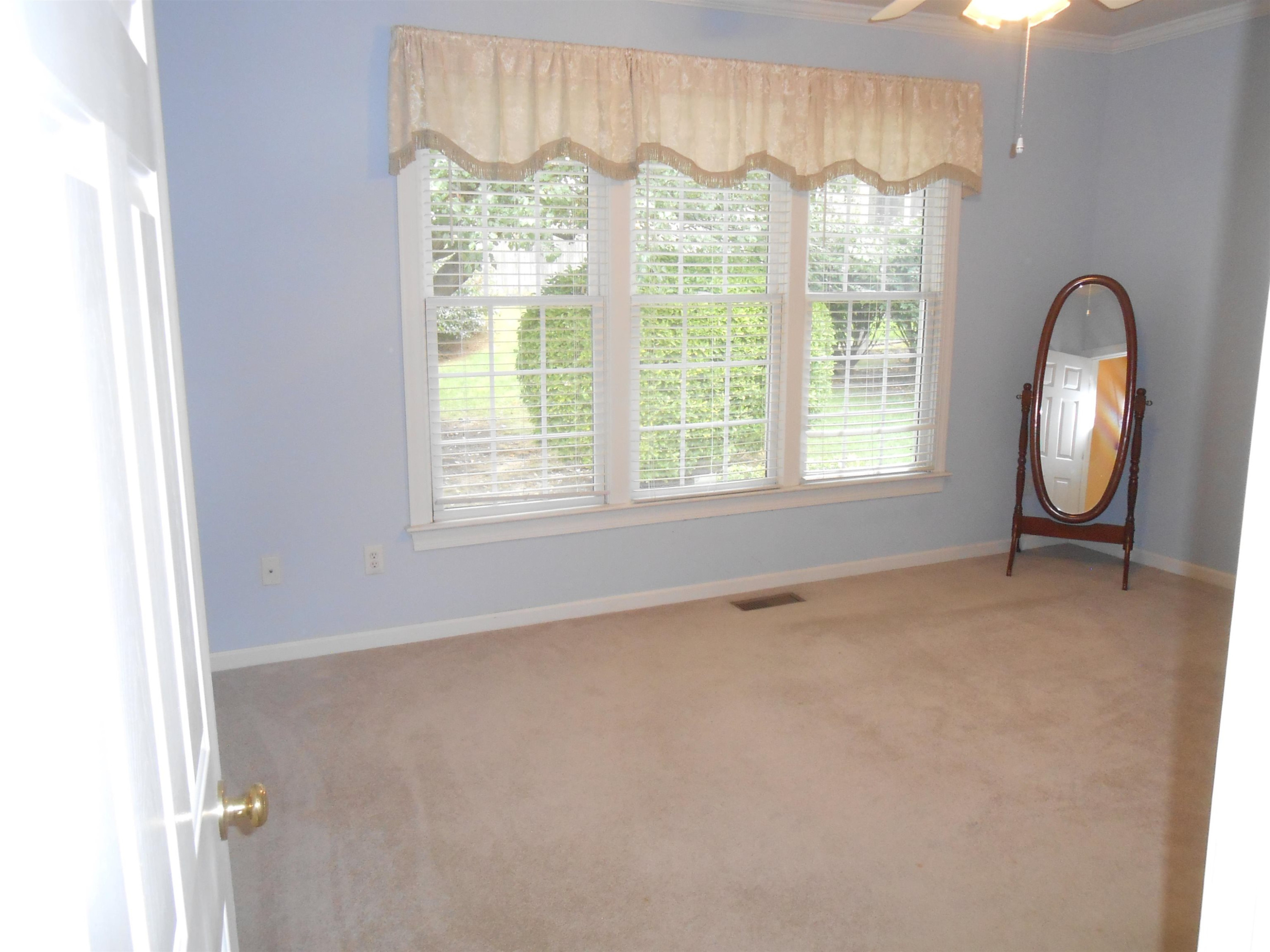 7937 Milltrace Run Raleigh, NC 27615 - Photo 18 of 34 a view of an empty room with a window and a mirror