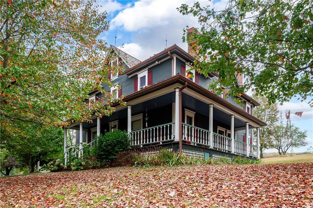 227 Aggas Road West Sunbury, PA 16061 - Photo 3 of 50 a front view of a house with a garden