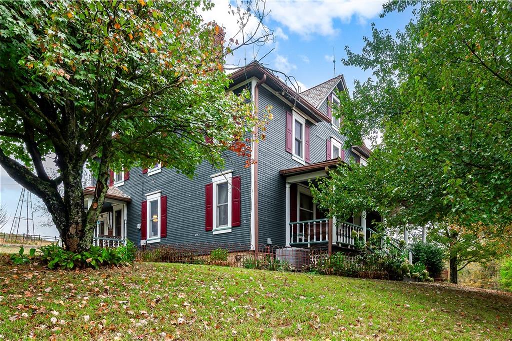 227 Aggas Road West Sunbury, PA 16061 - Photo 4 of 50 a front view of a house with garden