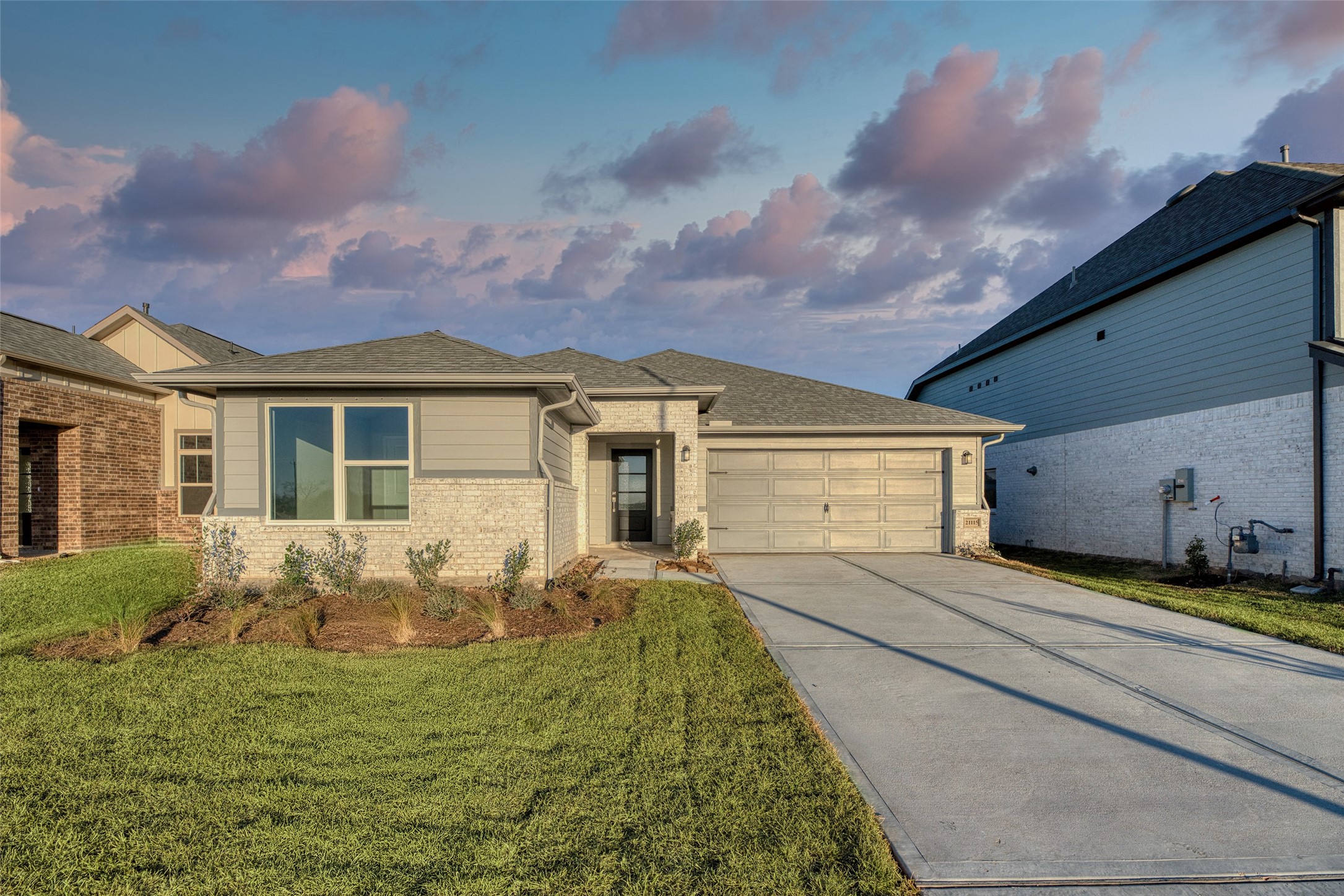 a front view of house with yard and trees around
