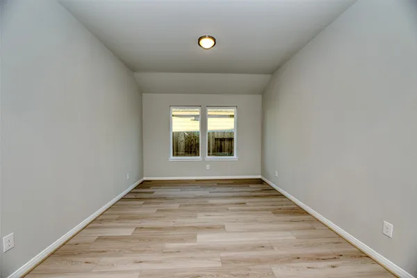 a view of an empty room with glass door