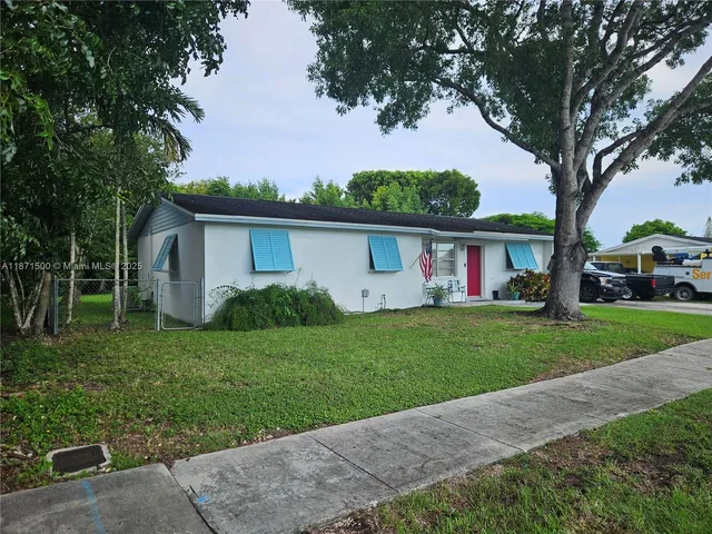 a view of house with car parked beside of road