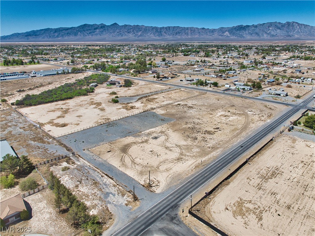 2081 Manse Road Pahrump, NV 89048 - Photo 10 of 18 Aerial view of sparsely populated area featuring a mountainous background and nearby suburban area