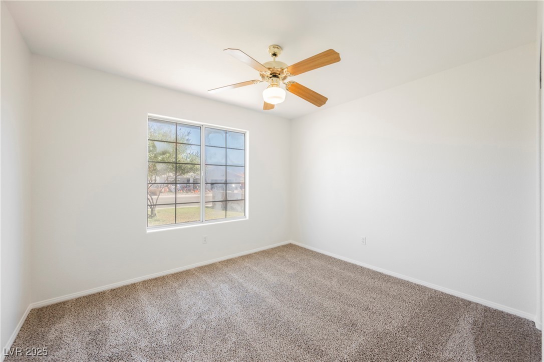 179 Grayce Mesquite, NV 89027 - Photo 10 of 25 Carpeted empty room with baseboards and ceiling fan