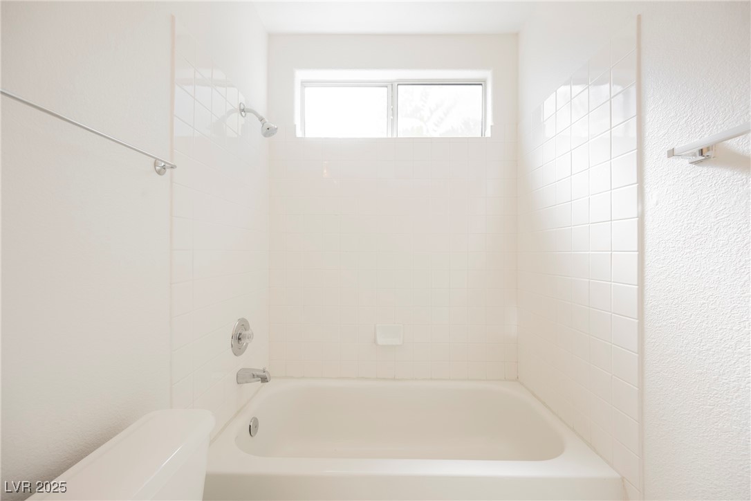 179 Grayce Mesquite, NV 89027 - Photo 14 of 25 Bathroom featuring shower / tub combination and a textured wall
