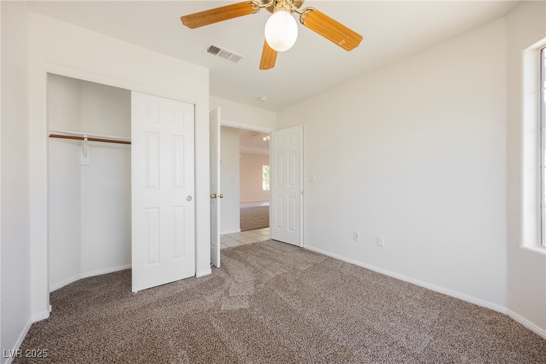 179 Grayce Mesquite, NV 89027 - Photo 17 of 25 Unfurnished bedroom with carpet flooring, a closet, and ceiling fan