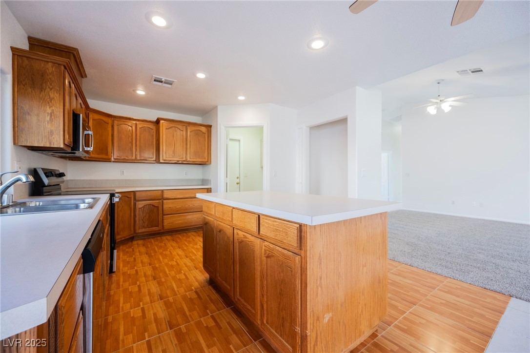 179 Grayce Mesquite, NV 89027 - Photo 25 of 25 Kitchen with brown cabinets, recessed lighting, light countertops, stainless steel appliances, and open floor plan