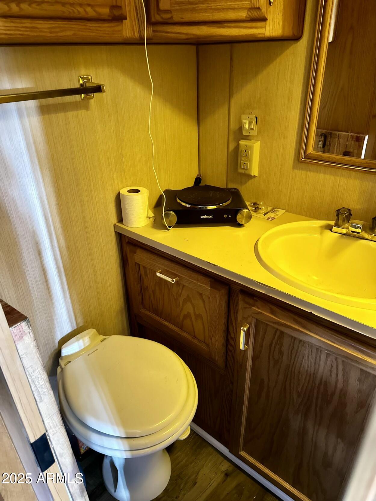 0 South Burro Pass Road, Unit 76 Morristown, AZ 85342 - Photo 12 of 18 a bathroom with a sink and toilet