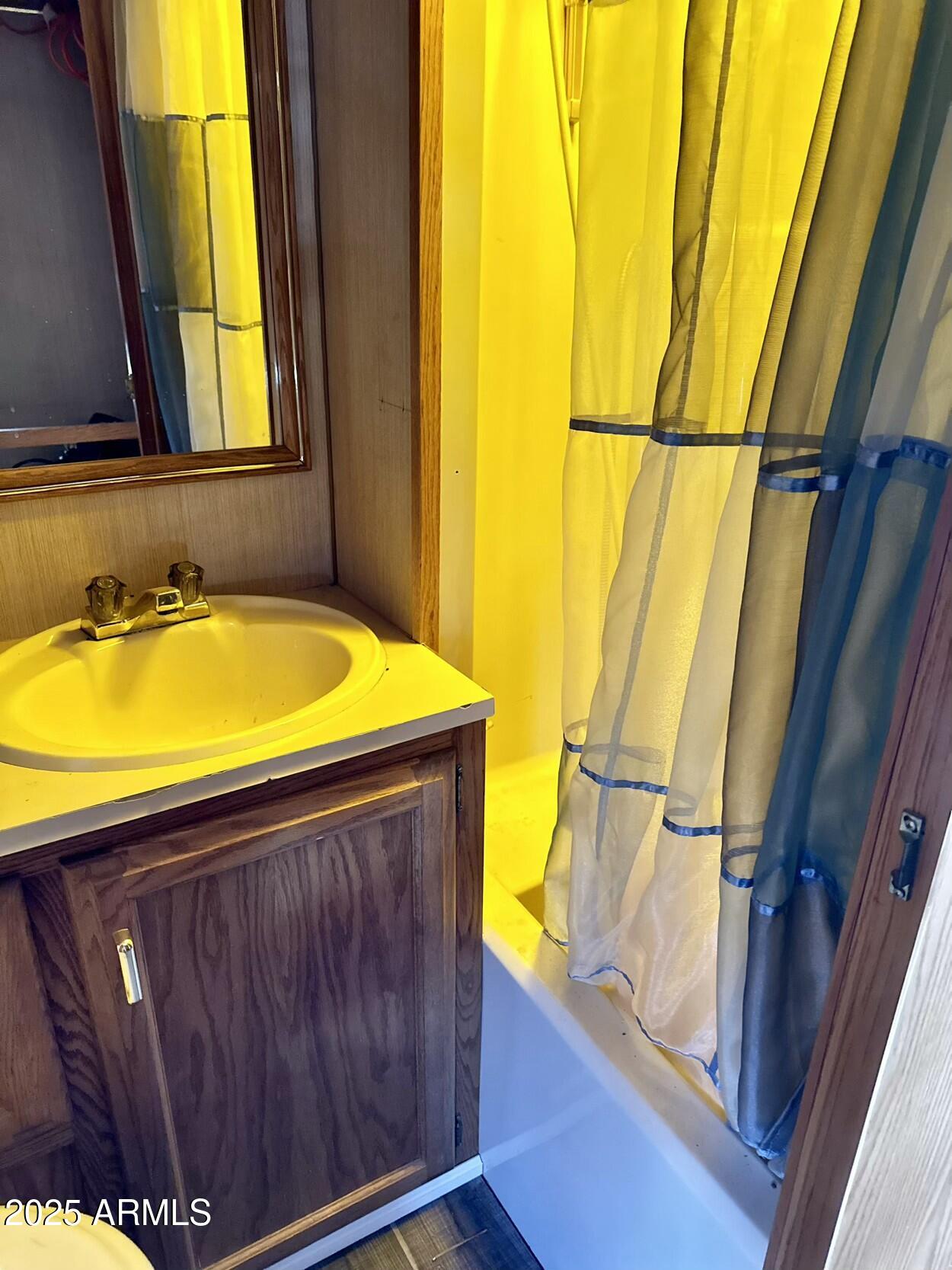 0 South Burro Pass Road, Unit 76 Morristown, AZ 85342 - Photo 13 of 18 a bathroom with a sink and a mirror
