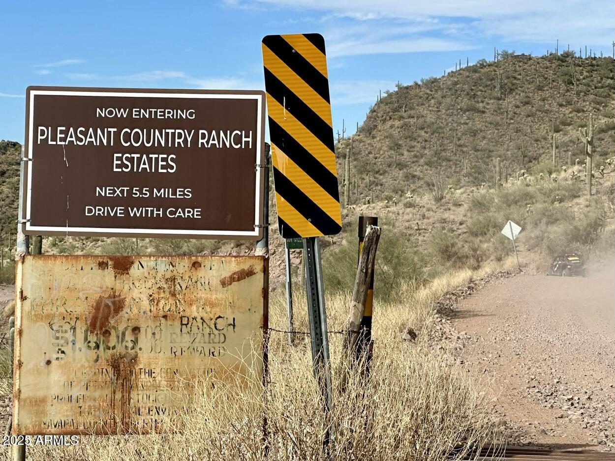 0 South Burro Pass Road, Unit 76 Morristown, AZ 85342 - Photo 15 of 18 a sign board on the wall of building