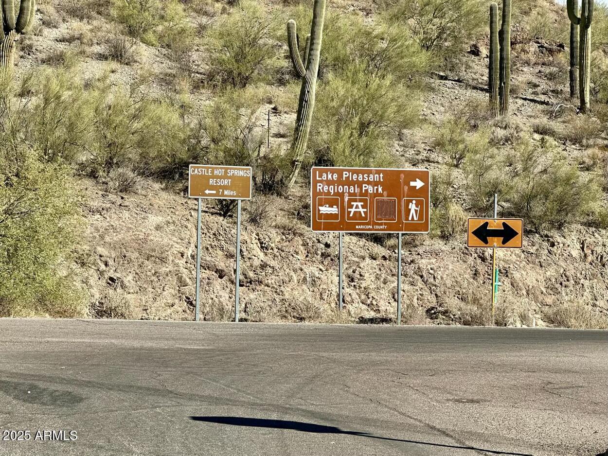 0 South Burro Pass Road, Unit 76 Morristown, AZ 85342 - Photo 17 of 18 a sign that is on the side of a road