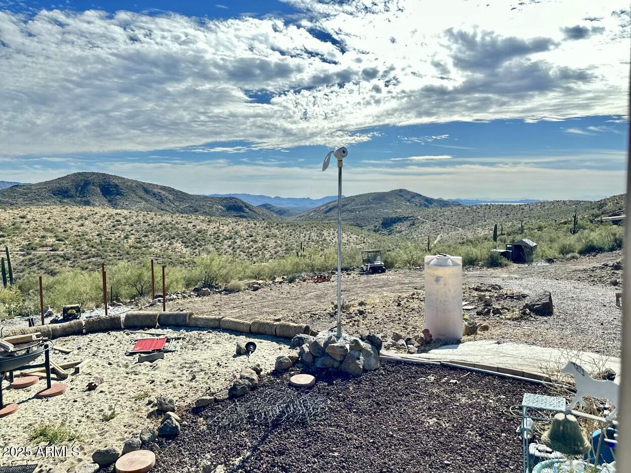 0 South Burro Pass Road, Unit 76 Morristown, AZ 85342 - Photo 6 of 18 a view of a backyard with table and chairs