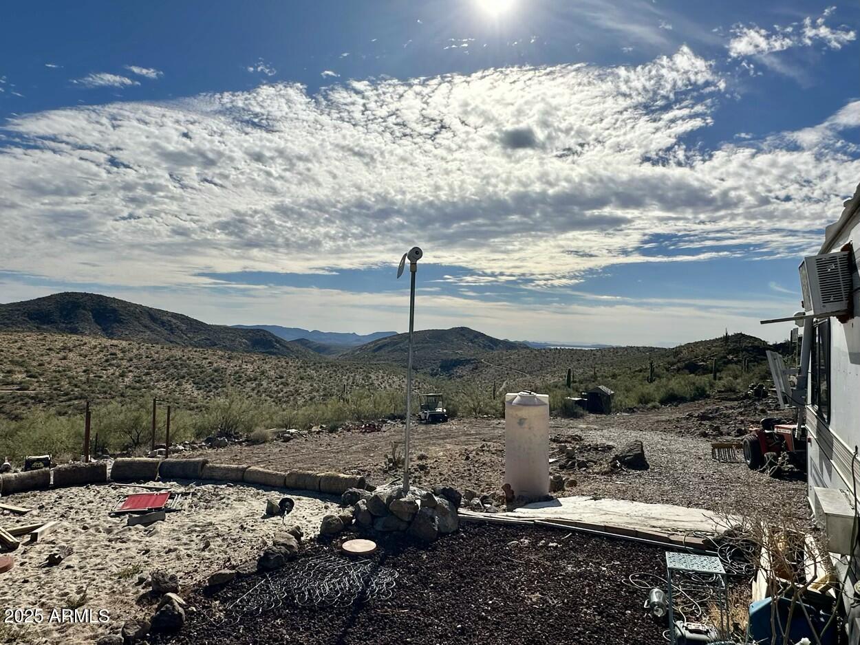 0 South Burro Pass Road, Unit 76 Morristown, AZ 85342 - Photo 9 of 18 a view of a yard with wooden fence