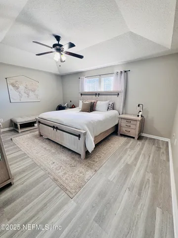a bedroom with a bed and a ceiling fan